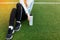 Girl resting after a good workout. Girl after exercise, drinking water on the football field. Portrait of beautiful girl in sports