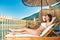 Girl resting on a sun lounger on the beach