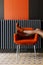 The girl rests her legs on a chair. Orange boots, a chair and part of the wall in a black conference room at the hotel. Relaxation