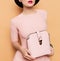 Girl in retro style. Accessories hat and bag. Vanilla style fashion