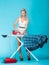 girl retro style ironing male shirt, woman housewife in domestic role.