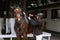 Girl rider adjusts saddle on her horse to take part in horse races