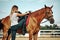 Girl rider climbs a horse. leather boot in stirrup. Horseback Riding