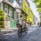 Girl rides bicycle up the street in Montmartre in old Paris