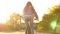 Girl rides a bike through city streets. Beautiful teenage girl rides bicycle in park on street, sunny day. Girl is