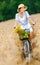 Girl rides cycle with apples and flowers