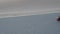 Girl rides on a skateboard on a desert road among the sand dunes. Close up.