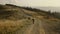 Girl riding bicycle on road. Athlete on sport bike cycling in landscape