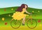 Girl is riding bike on flowering spring field