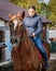 Girl riding chestnut horse