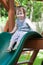 Girl riding on childrens slides on playground