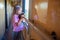 A girl is riding in a compartment carriage with a kitten. Traveling with pets by train