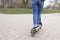 Girl riding a electric scooter in the park. Technological eco-friendly transport. Modern active lifestyle