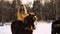 Girl riding a horse on a ranch. Fashionable beautiful girl stroking a horse. A quiet Sunny winter`s day. it`s snowing
