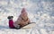 girl riding on snow slides in winter time
