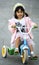 Girl riding tricycle