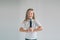 Girl Rocking Out. Image of a child singing to the microphone, isolated on light. Emotional portrait of an attractive kid