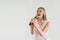 Girl Rocking Out. Image of a women singing to the microphone, isolated on light. Emotional portrait of an attractive kid