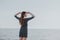 Girl on the rocky beach looks at sea