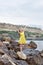 Girl on rocky seashore in rainy day