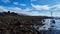 girl on the rocky shore of the sea looks at the landscape