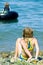 Girl on rocky shoreline