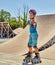 Girl roller skate helmet walking park. Child riding on roller skates.