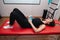 Girl rolls a ball on her stomach in a kinesiotherapy class. Rehabilitation physiotherapy, physical fitness, exercises for the