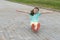 Girl rolls on the board with wheels on the asphalt