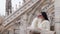 girl on the roof of famous Cathedral Duomo di Milano on piazza in Milan