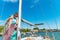 A girl with a rope on the deck of a yacht looks around, and holds the trunks on her shoulder.