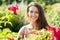 Girl in roses plants at garden