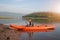 Girl rowing a canoe on calm waters