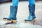 Girl in rubber boots outdoors in rainy day