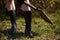 Girl in rubber boots with shovel and rake