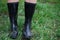 Girl in rubber boots with shovel and rake