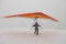 Girl run on snow with colorful hang glider wing