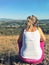 Girl runner sitting alone in the mountains.