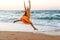 Girl running along the surf