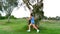 Girl running around a big tree