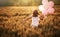 Girl running on cereal field