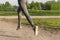 Girl running in the Park, women`s feet in gray leggings and sneakers on the path in the Park in the sun, runner