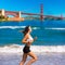 Girl running San Francisco Golden Gate Bridge