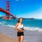 Girl running San Francisco Golden Gate Bridge