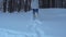 A girl runs across large snow drifts