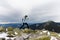 Girl runs along the rocks on the mountain top