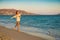 Girl runs along the surf line