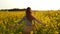 Girl runs arms outstretched through a field slowmo