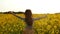 Girl runs arms outstretched through a field slowmo