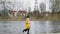 Girl runs in slow motion with bouquet with roses along the river beach, happy